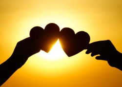 35291170 - hands holding hearts silhouette